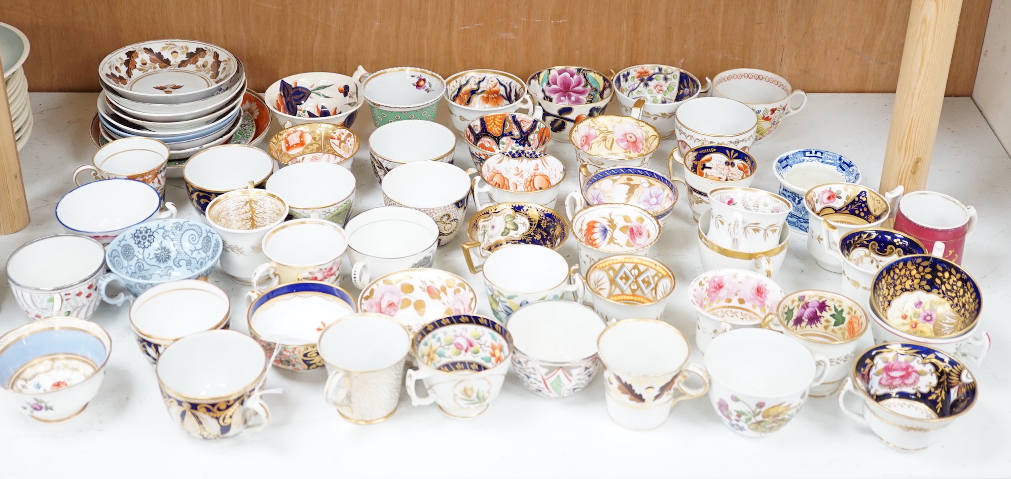 A group of Regency and Victorian porcelain tea, coffee cups and saucers, Newhall, Chamberlains, Coalport, etc.